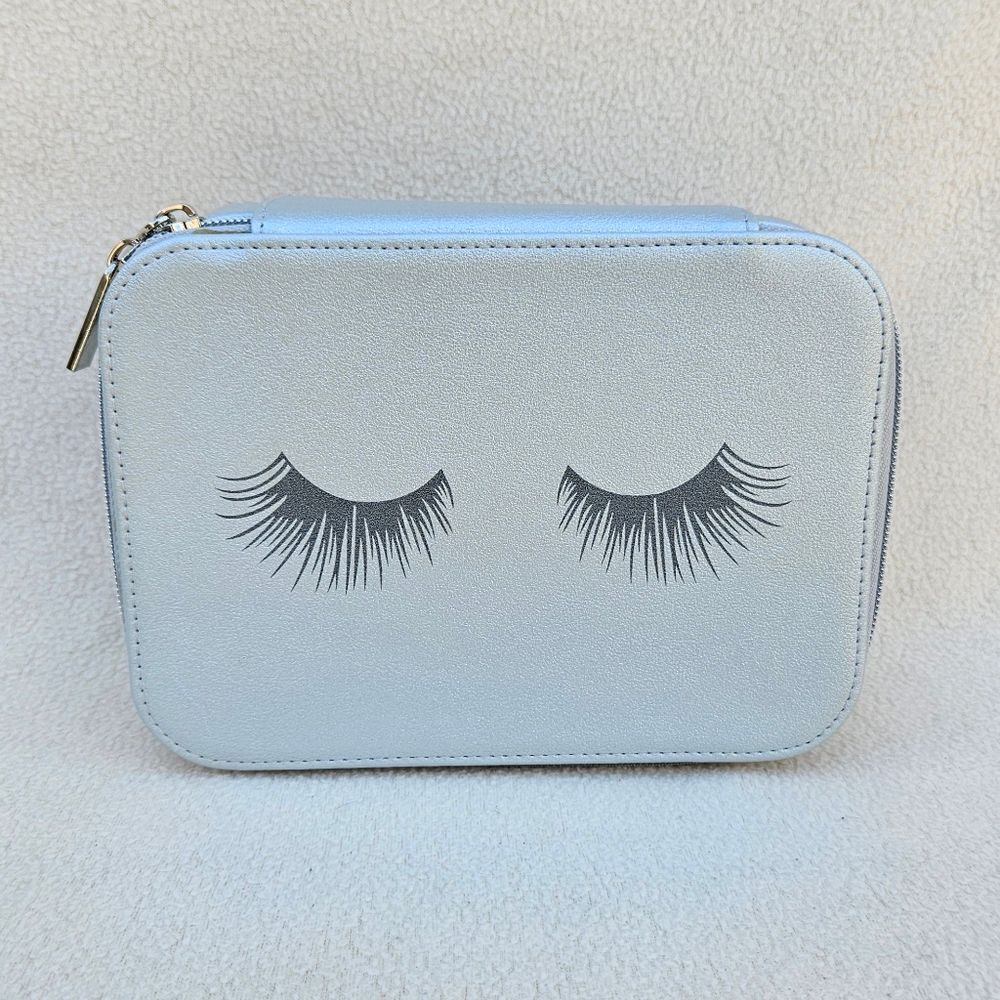 Neiman Marcus Silver Cosmetic Case with Eyelashes on the Front